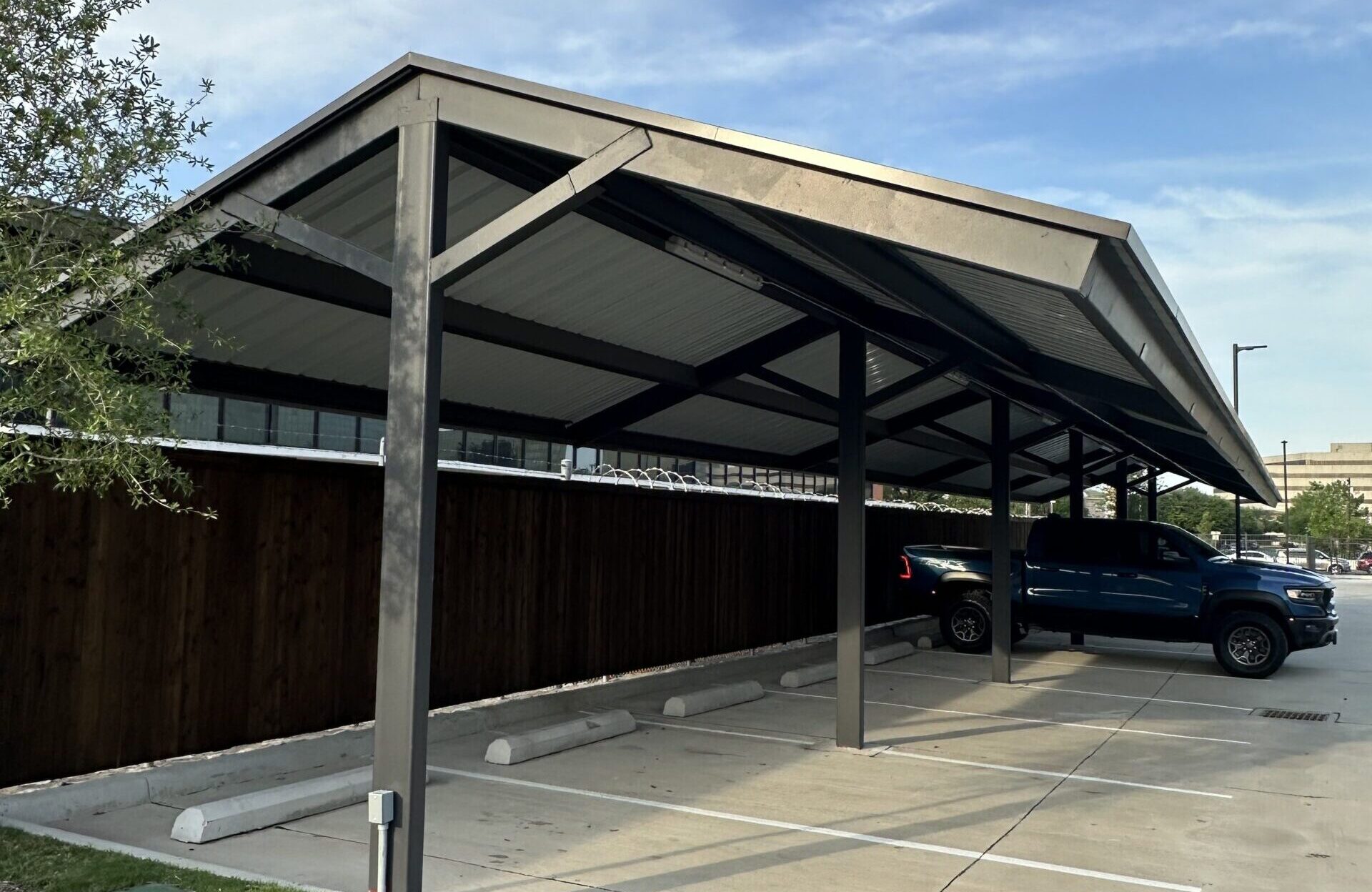 Parking lot carport installation with steel columns