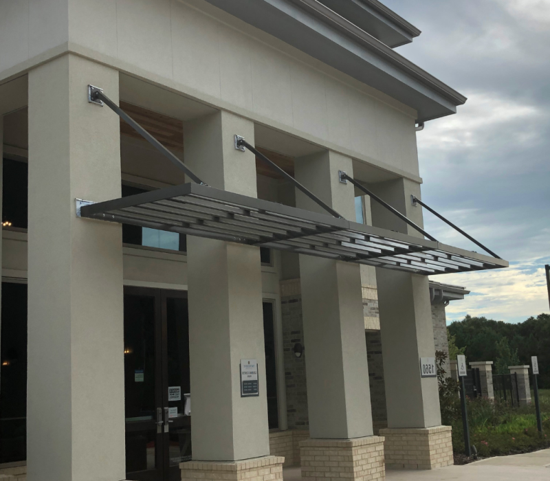 Commercial entrance with aluminum sunshade awnings