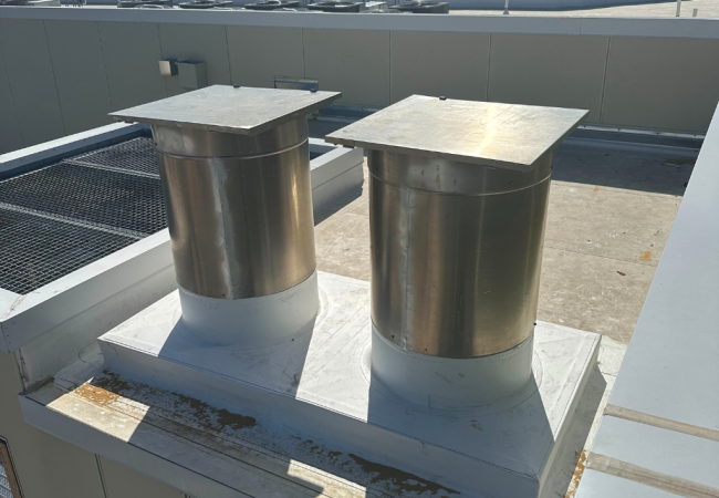 Rooftop vent system next to commercial trash chute exit